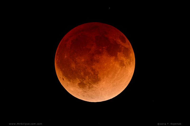 A total lunar eclipse looks red. Why?