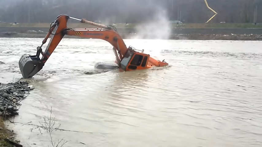 Difficult Moments of Excavator on the River