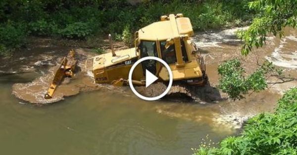 Skilled machine operator removes his CAT D6N from creek